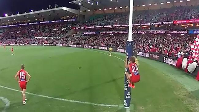 Dane Rampe scales the goal post as David Myers attempts a post-siren shot at goal.