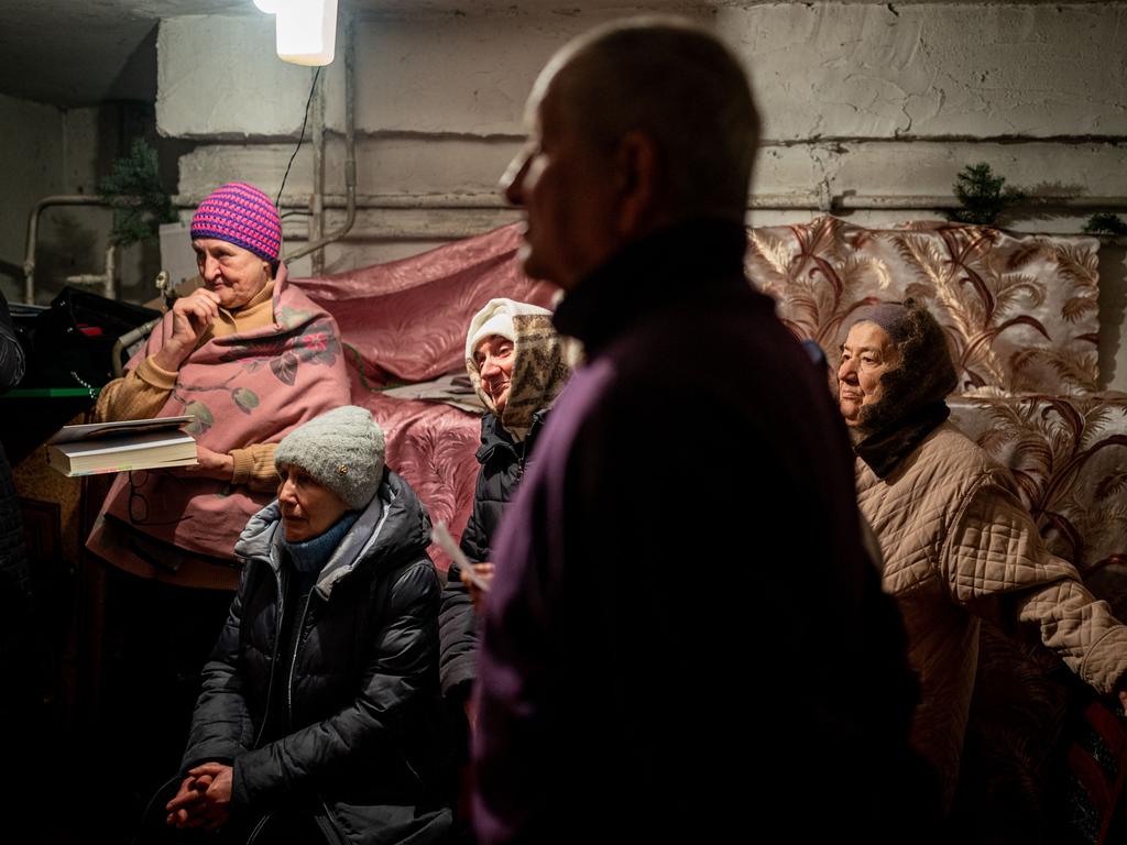 Worshippers pray during an Orthodox Christmas mass in a basement shelter in Chasiv Yar, Eastern Ukraine, as artillery boomed outside and fighter jets flew overhead. Picture: AFP