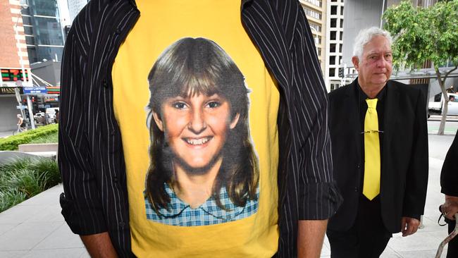 A t-shirt displaying a photograph of the victim Annette Mason, is seen as her father, Mick Mason walks outside the Brisbane Coroners Court. Picture: AAP Image/Darren England