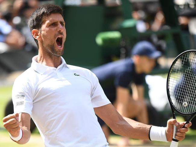 Serbia's Novak Djokovic celebrates beating Spain's Roberto Bautista Agut during their men's singles semi-final match on day 11 of the 2019 Wimbledon Championships at The All England Lawn Tennis Club in Wimbledon, southwest London, on July 12, 2019. (Photo by Ben STANSALL / AFP) / RESTRICTED TO EDITORIAL USE