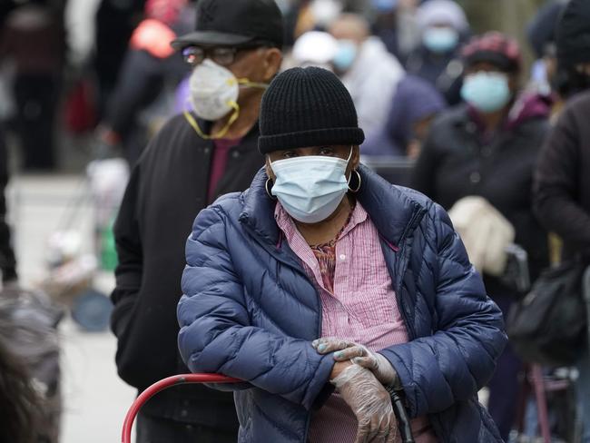 People line up outside the New York City Housing Authority for food distribution. Picture: AFP