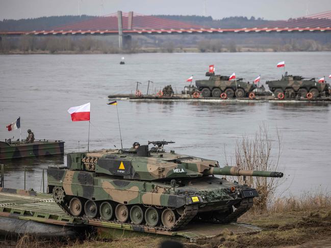 A Leopard 2A4 tank of the Polish armed forces arrives after crossing the Vistula river during the NATO DRAGON-24 military exercise.