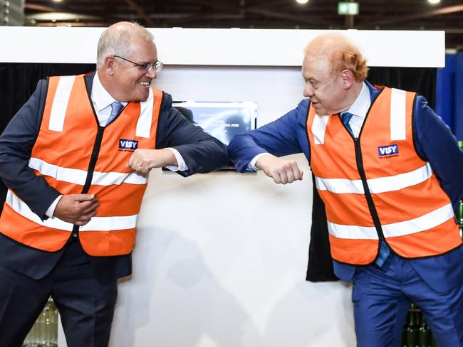 SYDNEY, AUSTRALIA - NCA NewsWire Photos FEBRUARY 26, 2021 Prime Minister Scott Morrison and Visy Executive Chairman Anthony Pratt elbow bump during a visit to Visy Manufacturing in Penrith. Picture: NCA NewsWire/Flavio Brancaleone