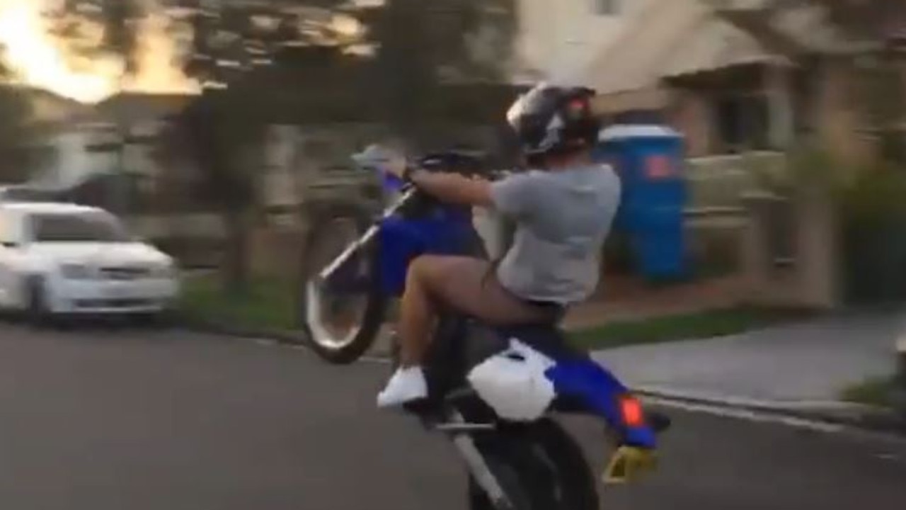 Younger brother Hadi Skaf does a burn on his motorcycle up the street near the Skaf family home.