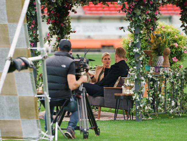 The pair, sitting underneath a romantic floral arch, looked like they were in deep conversation. Picture: Supplied