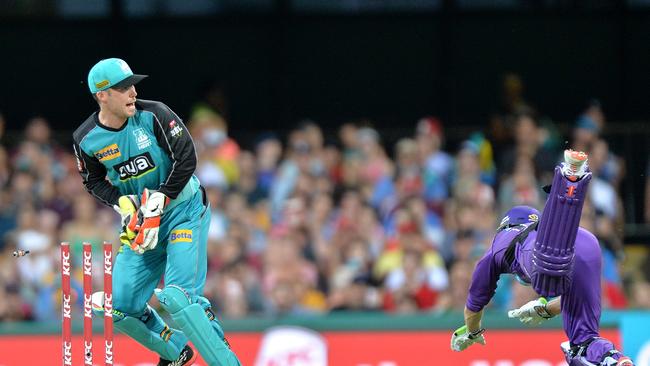 George Bailey of the Hurricanes is caught short of his ground by wicketkeeper Jimmy Peirson of the Heat during a Big Bash League match-up