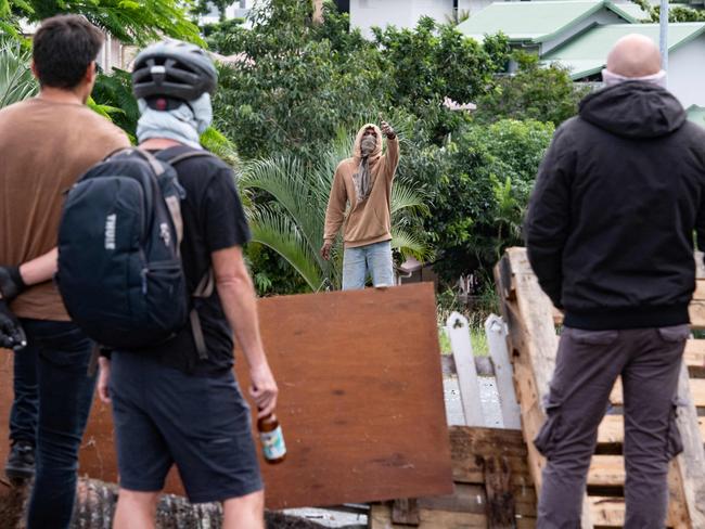 Masked residents watch an activist in Noumea amid protests. Picture: AFP