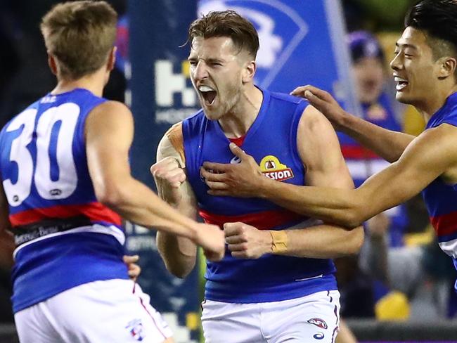 MELBOURNE, AUSTRALIA - AUGUST 04:  Marcus Bontempelli of the Bulldogs is congratulated by Lin Jong of the Bulldogs and his teammates after kicking a goal during the round 20 AFL match between the St Kilda Saints and the Western Bulldogs at Etihad Stadium on August 4, 2018 in Melbourne, Australia.  (Photo by Scott Barbour/Getty Images)