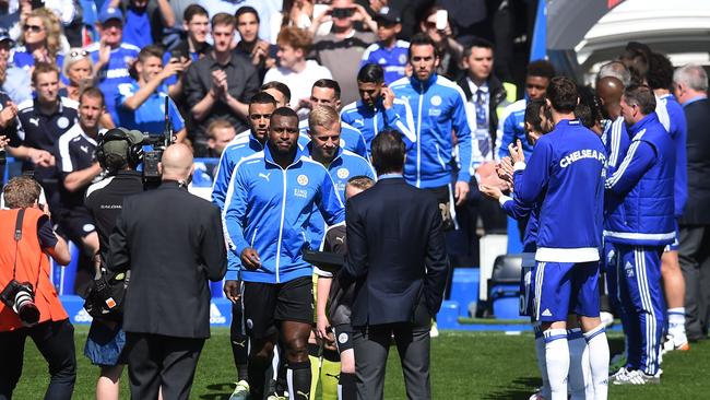 Leicester City players receive the guard of honour from Chelsea players.