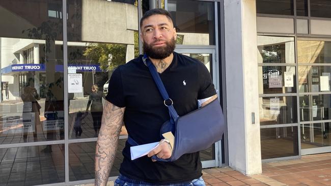 John Lavulo wearing a sling outside Campbelltown Court.