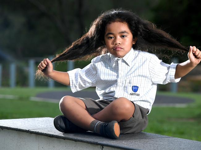 Wendy Taniela with her 5 year old son Cyrus Taniela in a play ground in Upper Caboolture.The mother of a five-year-old boy with long hair says his Caboolture school, Australian Christian College Moreton, told them it had to be cut despite his hair cutting ceremony, which is part of his father’s Cook Islands and Niuean heritage, being still a year awayMonday February 10,2020. (AAP image, John Gass)