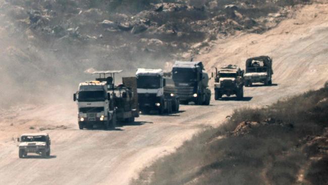 A convoy of Israeli civilian and military vehicles drives through the Gaza Strip along the Israel's southern border with the Palestinian territory on July 2, 2024, amid the ongoing conflict between Israel and the Palestinian militant group Hamas. (Photo by JACK GUEZ / AFP)