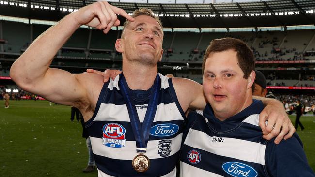 Joel Selwood produced one of the moments of the grand final when he helped Cats water boy Sam Moorfoot out of the crowd and onto the ground after his side’s win. Picture: AFL Photos/Getty Images