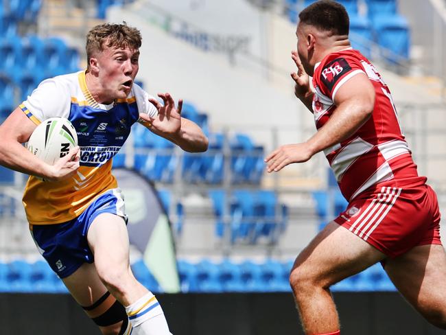 NRL National Schoolboys Cup final at CBUS Stadium  between Palm Beach Currumbin and Patrician Blacktown Brothers. Patrician Blacktown Brothers Jhett Sydir chased by PBCs Isaac Harrison.  .Picture Glenn Hampson