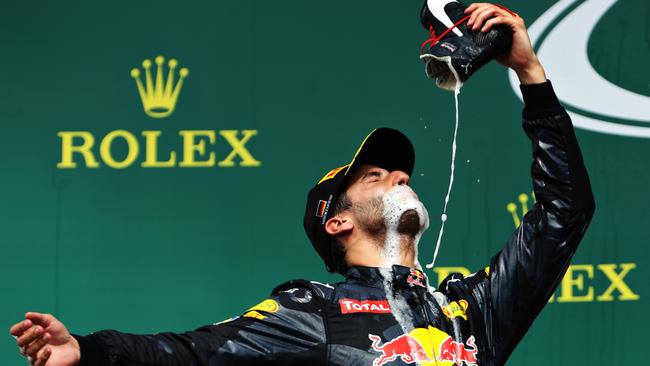 Daniel Ricciardo drinks champagne from his boot on the podium in Germany.