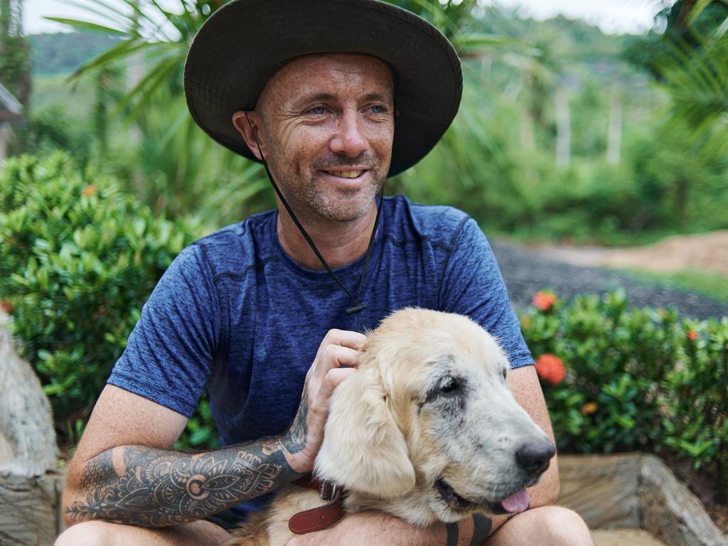 The dog that changed the world … Tina the rescued golden retriever, with Niall Harbison. Photo: Ryan Dunbar