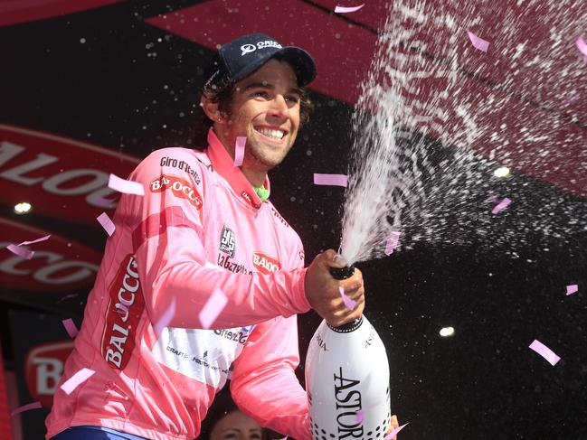 Australia's Michael Matthews sprays champagne as he celebrates retaining the overall leader's pink jersey after the fifth stage of the 97th Giro d'Italia, Tour of Italy, cycling race, 203 km from Taranto to Viggiano, on May 14, 2014 in Viggiano. AFP PHOTO/LUK BENIES