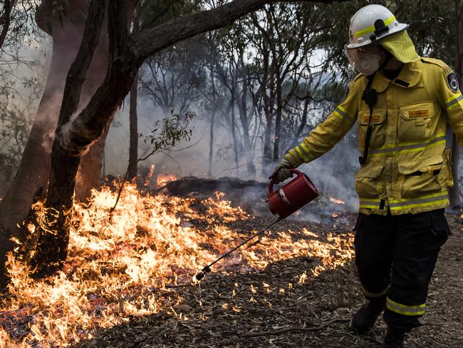 A hazard reduction burn carried out by Rural Fire Service and National Parks and Wildlife Service near homes at Mount Colah today. Picture: Dylan Robinson