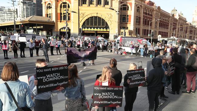 Animal rights protesters block the intersection of Flinders and Swanston Streets during early morning traffic in Melbourne in April. Picture: AAP