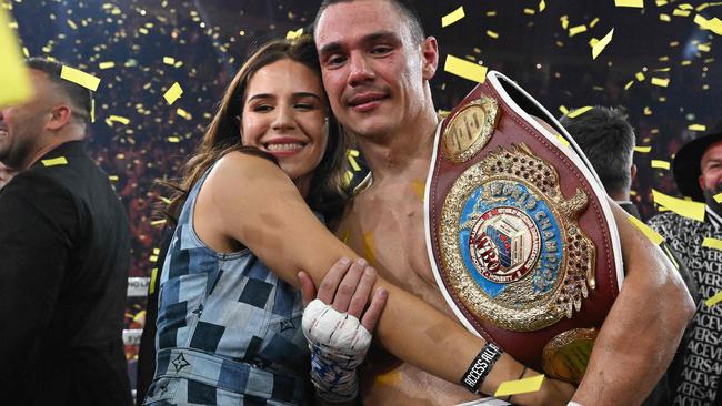 Australian boxer Tim Tszyu (R) celebrates with his partner Alexandra Constantine following his victory over USA's Tony Harrison in their WBO super welterweight world title bout at Qudos Bank Arena in Sydney on March 12, 2023. (Photo by Saeed KHAN / AFP) / -- IMAGE RESTRICTED TO EDITORIAL USE - STRICTLY NO COMMERCIAL USE --