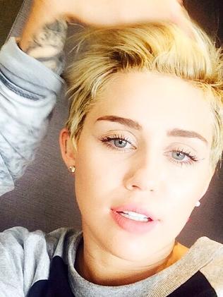 Miley Cyrus tops up her tan in Sydney as the pop star goes topless to ...