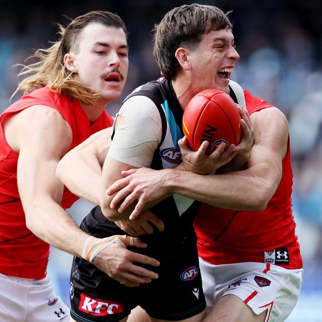 Two Bombers try to put the clamps on Zak Butters.