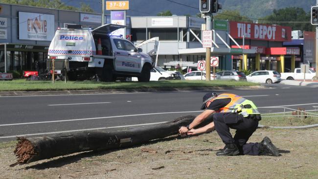 Police photograph a light pole ripped from the ground on Anderson St this morning. Picture: Peter Carruthers