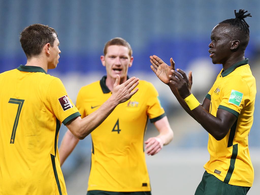 Awer Mabil (right) celebrates with Craig Goodwin (left) and debutant Kye Rowles (centre) after scoring in the Socceroos’ 2-1 win over Jordan, Picture: Mohamed Farag/Getty Images