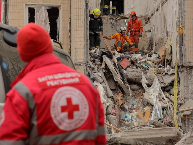 Rescuers work at the site of a heavily damaged multi-story apartment building, following a Russian drone attack, in Odesa, on March 2, 2024. (Photo by Oleksandr GIMANOV / AFP)