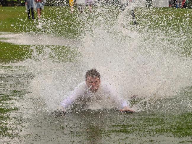 Who needs a slip ‘n slide when you have Flemington racecourse? Picture: Jason Edwards