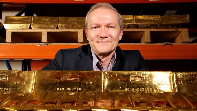 Deputy CEO of Perth Mint Joe Metcalfe with gold stored in front and behind him on Thursday. Picture: Colin Murty