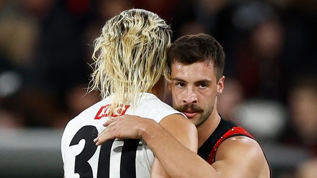 MELBOURNE, AUSTRALIA - APRIL 25: Darcy Moore of the Magpies and Kyle Langford of the Bombers embrace after a draw during the 2024 AFL Round 07 match between the Essendon Bombers and the Collingwood Magpies at the Melbourne Cricket Ground on April 25, 2024 in Melbourne, Australia. (Photo by Michael Willson/AFL Photos via Getty Images)