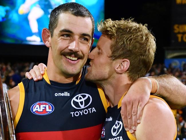 ADELAIDE, AUSTRALIA - APRIL 01:Rory Sloane of the Crows kisses Taylor Walker of the Crows holding the Showdown Shield  after the round three AFL match between Port Adelaide Power and Adelaide Crows at Adelaide Oval, on April 01, 2023, in Adelaide, Australia. (Photo by Mark Brake/Getty Images)