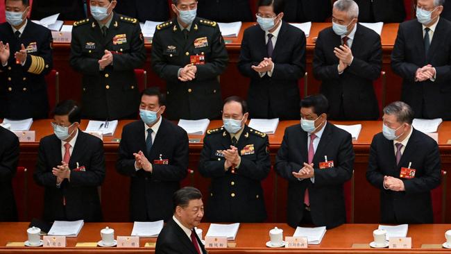 Delegates applaud as Xi Jinping arrives for the opening session of the National People's Congress. Picture: AFP