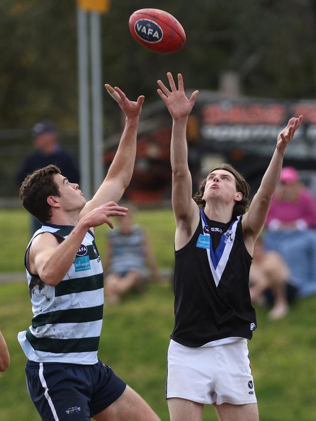 VAFA: Jack Sheridan of Old Geelong and Mazenod’s Fletcher Ford reach for the ball. Photo: Hamish Blair