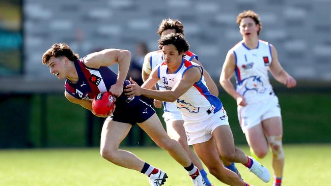 Olli Hotton is tackled by Alwyn Davey Jr. Picture: Kelly Defina/AFL Photos/via Getty Images