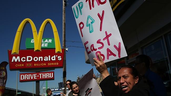 Fast food workers and activists protest outside of a McDonald&#39;s restaurant against the co