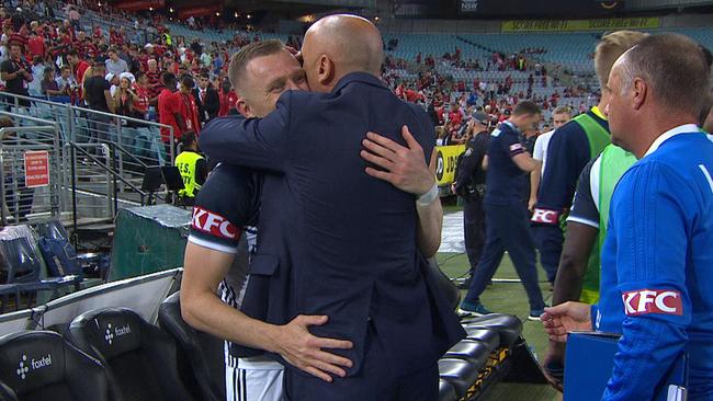 Besart Berisha and Kevin Muscat embrace.
