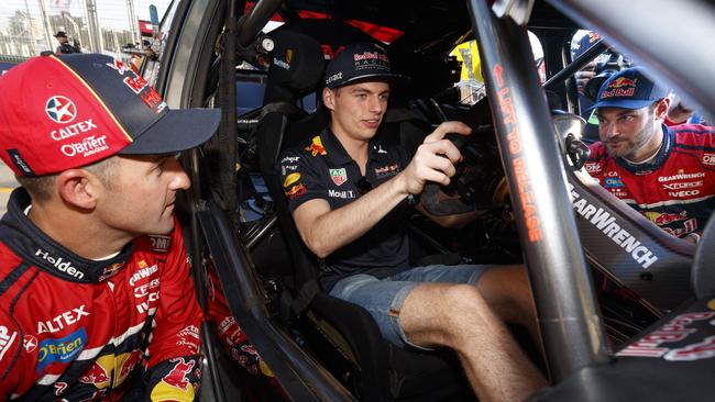 Max Verstappen gets a close look at a Supercar during the Australian Grand Prix in Melbourne.