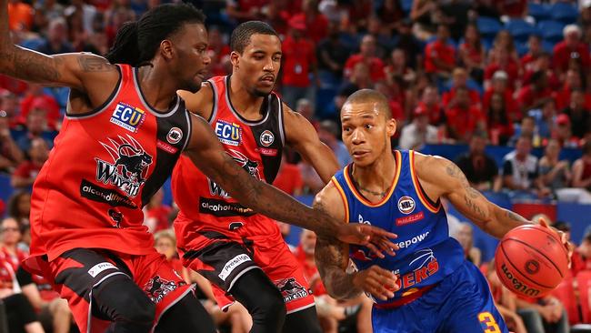 Jerome Randle ... a mature leader in a young Sixers side drives against Perth’s Jameel McKay. Picture: Paul Kane (Getty Images)