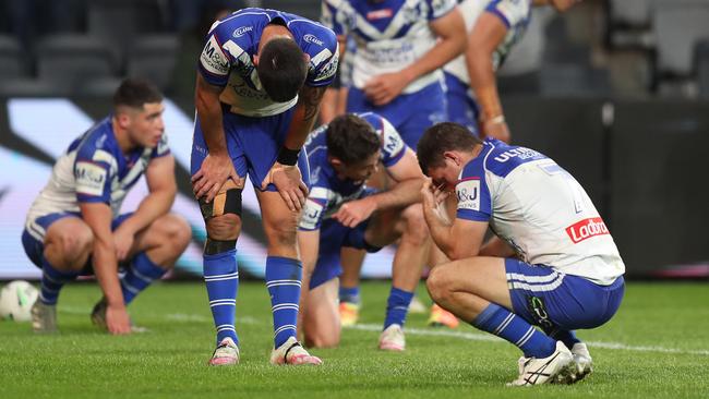 Dejected Bulldogs players at fulltime after their narrow loss to Wests Tigers. Picture: Brett Costello