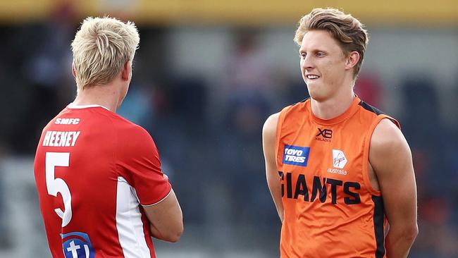 Giants star Lachie Whitfield, right, chats to Swan Isaac Heeney earlier this season. Picture: Matt King/Getty.