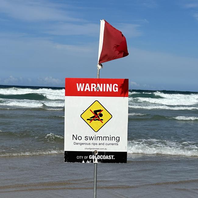 Warning signs have been placed across the entire section of the Broadbeach beach where the man reportedly drowned. Picture: Mohammad Alfares