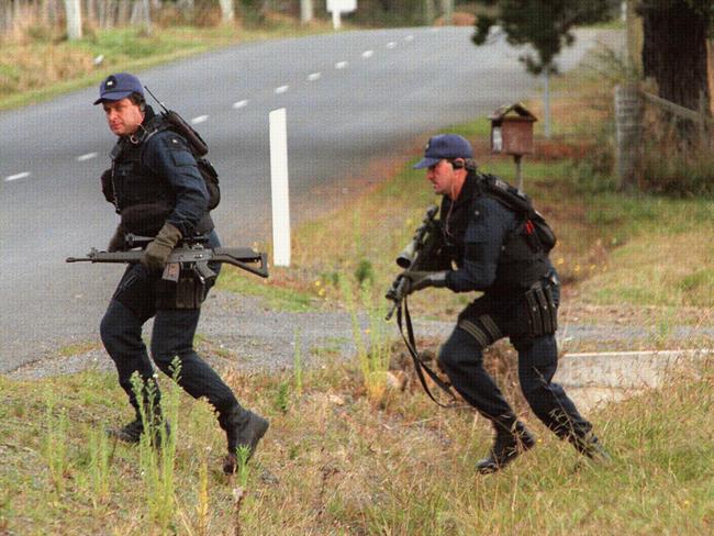 Special Operations police run for cover at the shooting scene near Port Arthur.