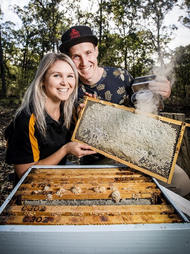 Buzzing: East Gippsland couple Stacey and Ben Murphy with one of their hives. Picture: Nicole Cleary