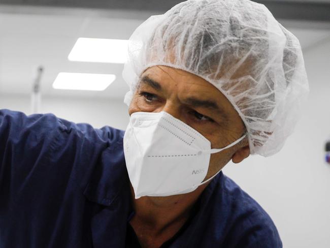 A worker at the Sion Medical factory, the country's first production line of N95 masks, produces a mask at the factory in the southern Israeli city of Sderot on, June 15 2020. - Israel said it had opened a factory to make millions of high-spec masks as it prepares for a possible "second wave" of coronavirus cases. "We are preparing for a second wave of the virus," said Defence Minister Benny Gantz, announcing the country's first production line of N95 masks. Gantz said the local production "removes our dependence on foreign factors and contributes to the Israeli economy during a difficult period." (Photo by MENAHEM KAHANA / AFP)