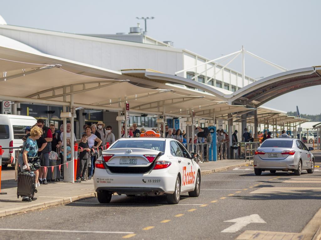 Travellers line up for a taxi at the Darwin International Airport on Friday at midday. Picture: Floss Adams.