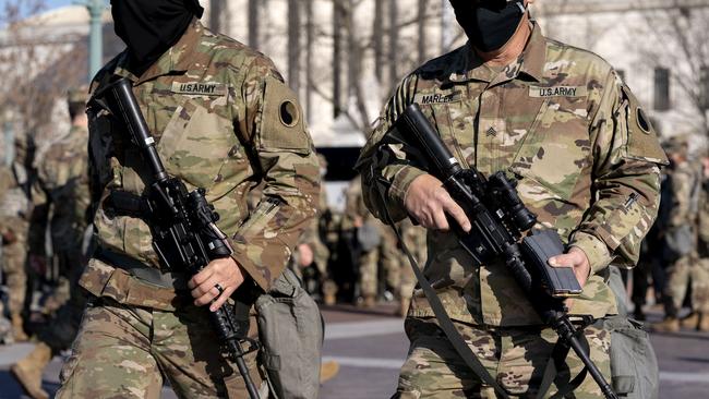 Members of the Virginia National Guard carry weapons outside the US Capitol on Friday. Picture: Getty Images/AFP