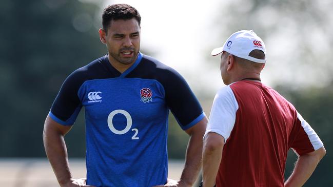 Ben Te'o talks to coach Eddie Jones during an England rugby team training session