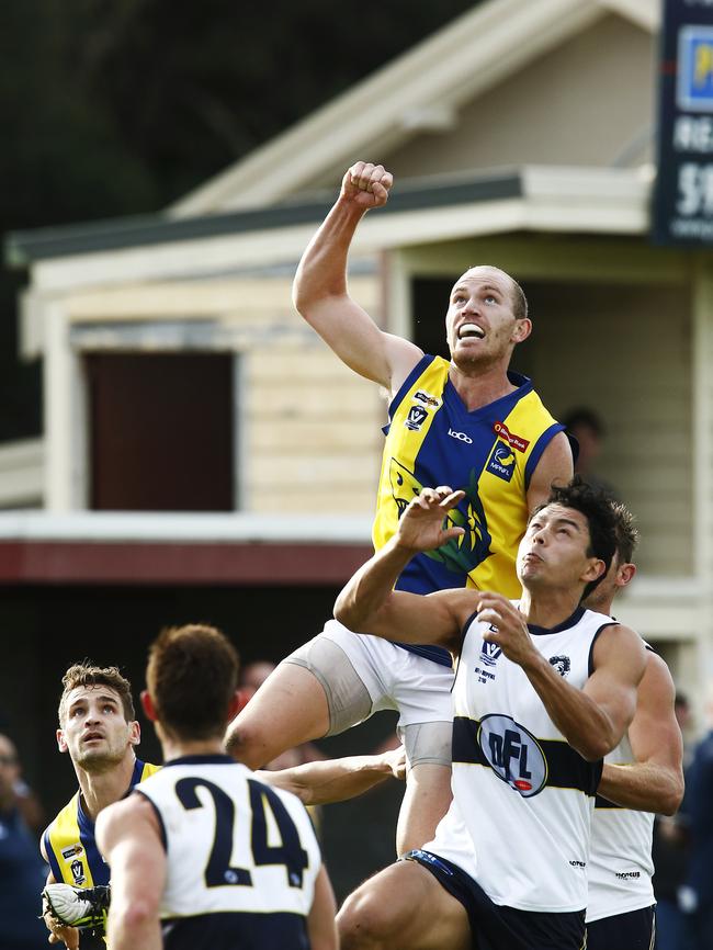 The MPNFL’s Anthony Bruhn soars high against Northern Football League’s Matthew Dennis at Rye on Saturday. Picture: Paul Loughnan